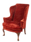 A Queen Anne carved walnut wing frame armchair,