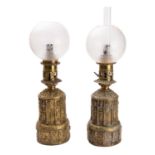 A matched pair of gilt repoussé brass table oil lamps, in Gothic taste,