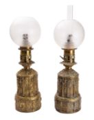 A matched pair of gilt repoussé brass table oil lamps, in Gothic taste,
