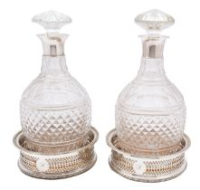 A pair of George V silver and glass decanters, marks rubbed, Birmingham 1929, of vase shape,