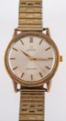 Omega a gentleman's gold wristwatch the champagne dial with raised gold and black baton numerals,