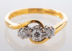 An 18ct gold, round, brilliant-cut diamond, three-stone, cross-over ring,