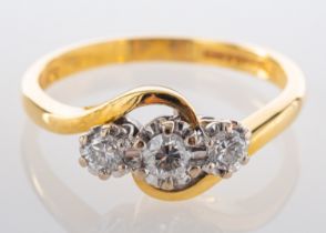 An 18ct gold, round, brilliant-cut diamond, three-stone, cross-over ring,