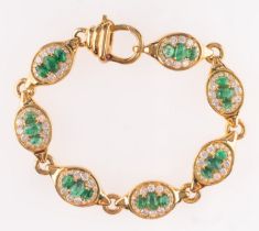 An oval, cabochon-cut emerald and round, brilliant-cut diamond bracelet,