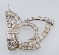 A diamond brooch, the scrolled openwork brooch set with old brilliant cut and baguette cut diamonds,