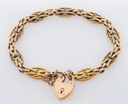 A 15ct gold gate bracelet, of fancy linking with a heart shaped padlock with safety chain.