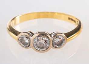 An 18ct gold and diamond ring, set with three brilliant cut diamonds, approximately 0.