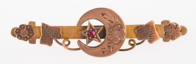 A 9ct gold brooch, with an applied crescent and star set with a doublet stone, with foliate detail,