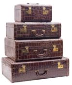 A mid 20th century American four piece crocodile skin set of travel cases,