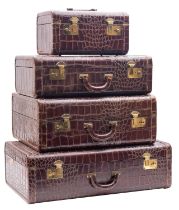 A mid 20th century American four piece crocodile skin set of travel cases,