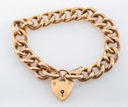 A 15ct gold bracelet, the large curb link chain supporting a 15ct gold heart shaped padlock,