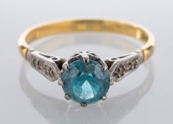 A round, mixed-cut blue zircon and single-cut diamond dress ring, stamped '18CT', ring size M1/2,