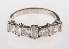 An 18ct gold and diamond ring, half set with alternating brilliant cut and baguette cut diamonds,