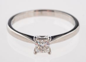 A platinum and diamond ring, the square cut diamond, estimated to weigh 0.