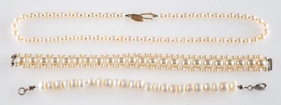 A cultured pearl necklace, composed of uniform cultured pearls, the clasp stamped 375,