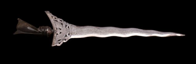 An Indonesian silver paper knife, in the form of a kris with buffolo horn handle,