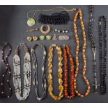 A small collection of jewellery including a citrine bead necklace; an amber bead necklace;