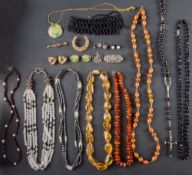 A small collection of jewellery including a citrine bead necklace; an amber bead necklace;