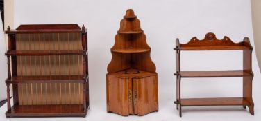 A Victorian stained pine four-tier graduated hanging bookcase; with turned column uprights;