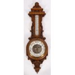 A late Victorian oak 'banjo' wall barometer,
