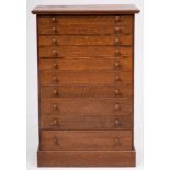 An Edwardian oak collectors chest, containing ten drawers on a plinth base, 85cm high, 56cm wide,
