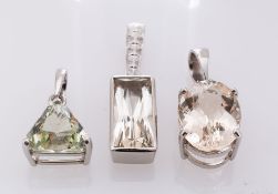 A Platinum Morganite Pendant, the oval shaped stone claw set, a Platinum Pale Green Helidor Pendant,