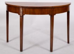 An early George III mahogany demi-lune table, circa 1770; previously one end of a dining table,