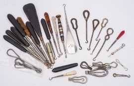 A collection of Victorian and later button hooks, including several advertising button hooks,