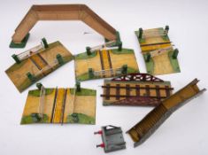 An unboxed group of four Hornby O gauge railway crossings, together with a railway bridge,