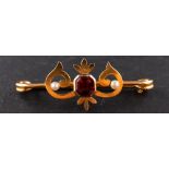 A garnet and seed pearl bar brooch, stamped '9CT', length ca. 4cm, total weight ca. 2.8gms.