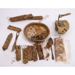 A small collection of excavated and salvaged militaria, including empty gun clips,