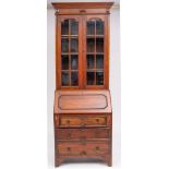 An Edwardian oak bureau bookcase in the Jacobean style; the upper part with a moulded cornice,