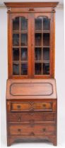 An Edwardian oak bureau bookcase in the Jacobean style; the upper part with a moulded cornice,