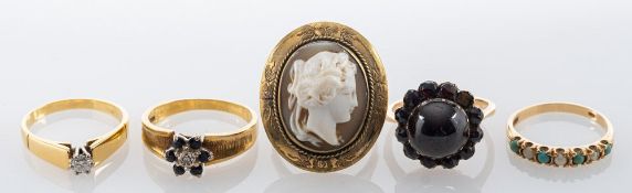 Five rings, including: a carved shell cameo ring, stamped 9ct,
