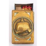 A WWI German brass match box, the obverse with embossed picklehaube in a circular cartouche,