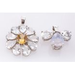 A platinum white topaz and quartz pendant, of fleur de lys design,