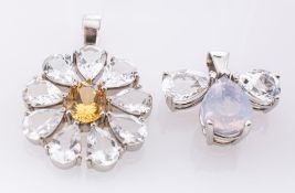 A platinum white topaz and quartz pendant, of fleur de lys design,