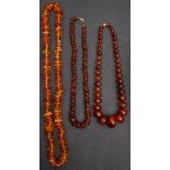 Three amber bead necklaces, including a necklace with amber beads of yellowish orange hue,