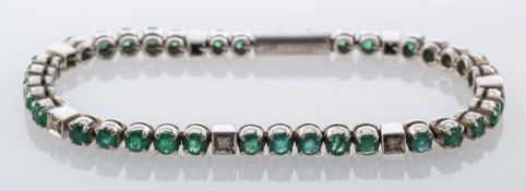 An emerald and diamond tennis bracelet,