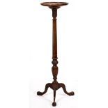 A mahogany torchere stand, in 18th-century taste, circa 1900; the circular top with fluted shaft,