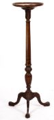 A mahogany torchere stand, in 18th-century taste, circa 1900; the circular top with fluted shaft,