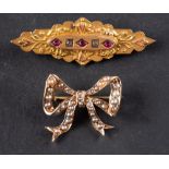 Two brooches, including a seed pearl set bow brooch; and a red and white paste set brooch,