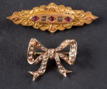 Two brooches, including a seed pearl set bow brooch; and a red and white paste set brooch,