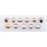 A collection of eleven gem set rings, including three illusion set three stone diamond rings,