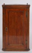 An oak hanging corner cabinet,