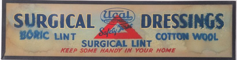 A Ucal 'Surgical Dressings' glass advertising sign 14 x 54cm