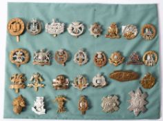 A collection of various regimental cap badges, including Tank Regiment, 9th Lancers,