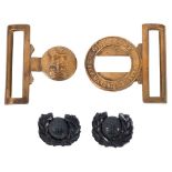 Two WWII Royal Marines Plastic Officer's Cap Badges, together with a Royal Marines waist belt clasp.