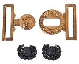 Two WWII Royal Marines Plastic Officer's Cap Badges, together with a Royal Marines waist belt clasp.