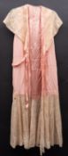 An early 20th century lady's pink silk and lace nightdress,